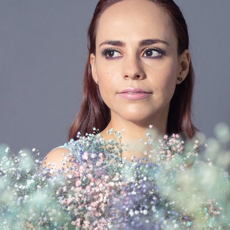 Kaveri Mehta, Lead Design Curator at SignalPathWay, reviewing corporate floral arrangements